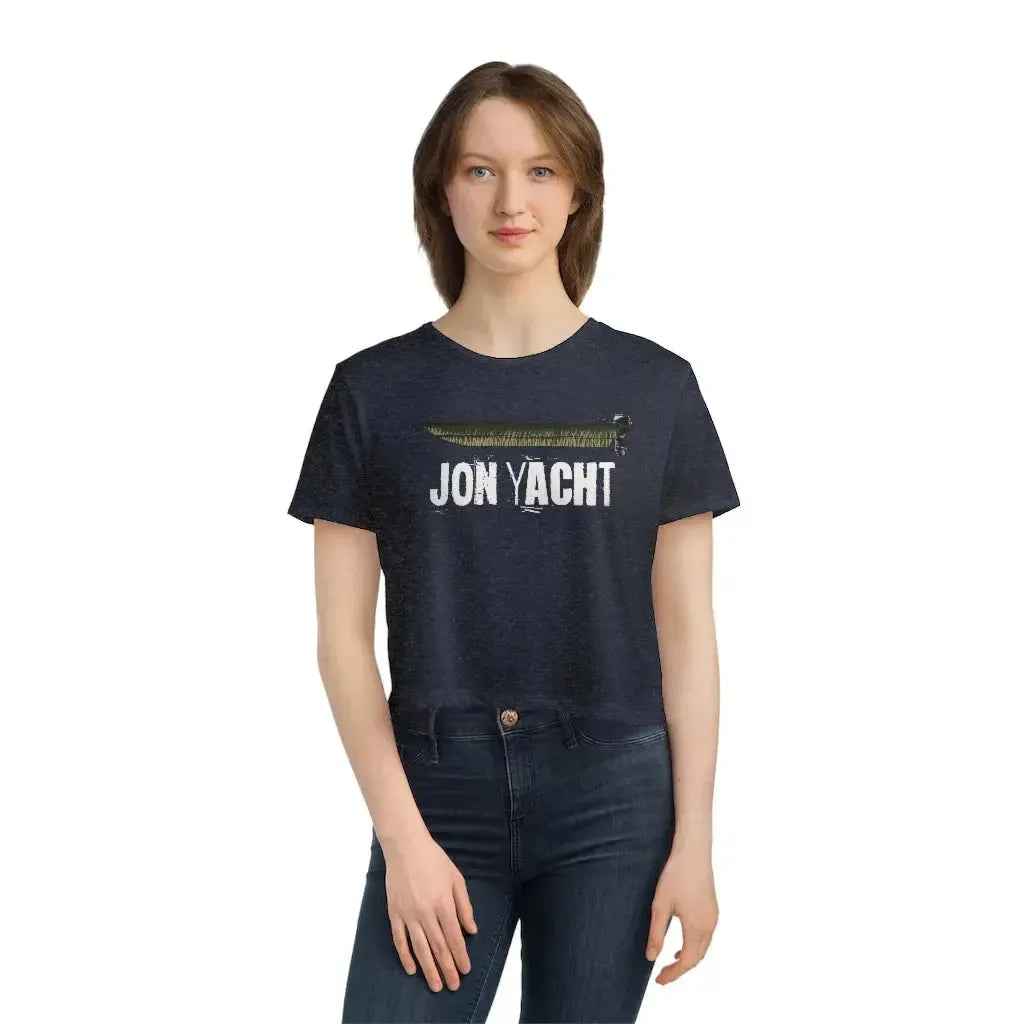 Woman wearing a navy blue flowy cropped tee with "JON YACHT" text and a boat graphic.