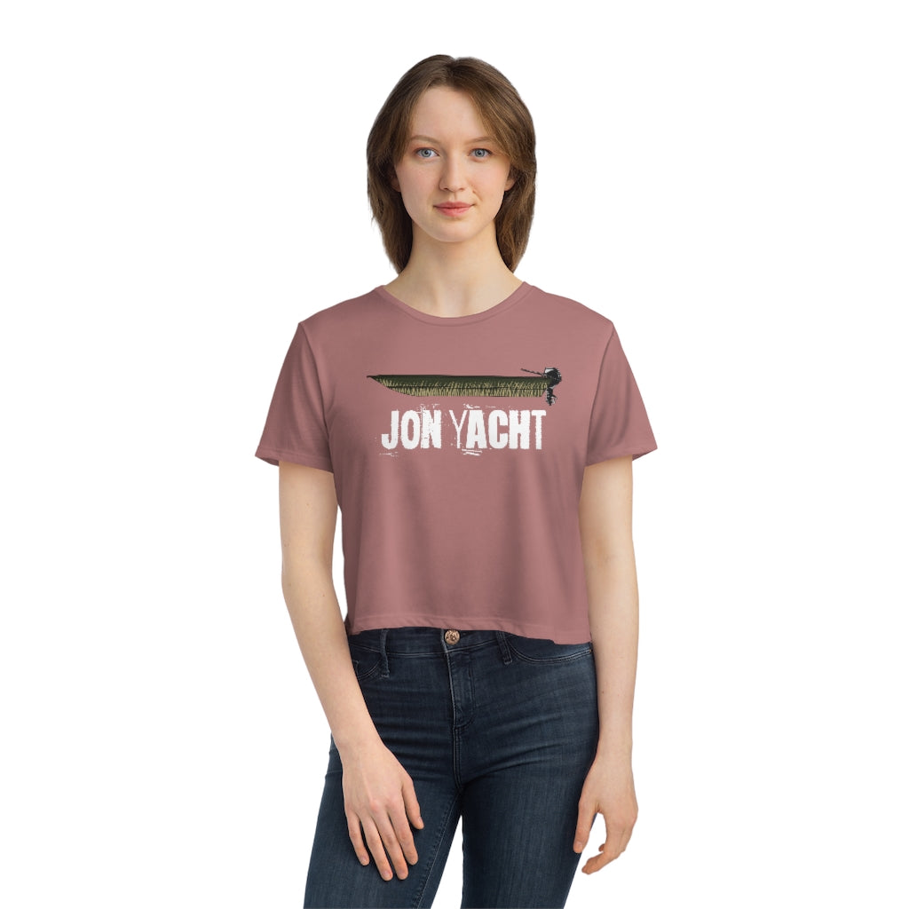 Woman in a flowy, modest crop tee in dusty rose with a "JON YACHT" graphic.