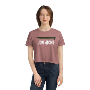 Woman in a flowy, modest crop tee in dusty rose with a "JON YACHT" graphic.