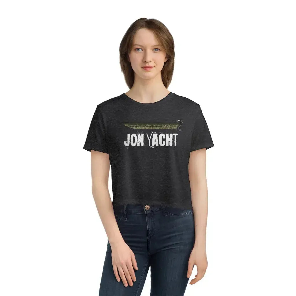 Woman wearing a dark gray flowy cropped tee with "JON YACHT" text and a boat graphic.