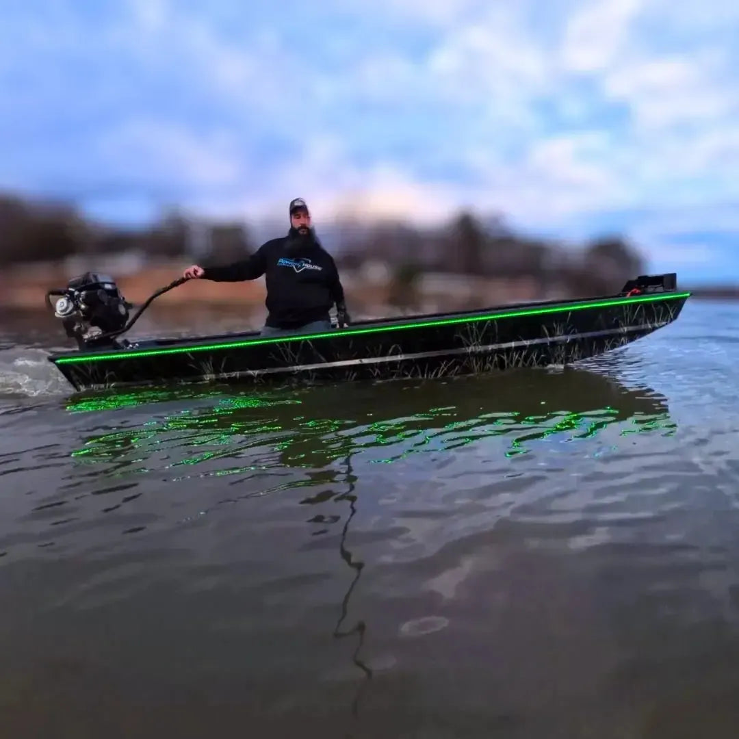 Custom Espresso over Black 1436 duck boat with green LED lights, 13hp mud motor, and driver on water.