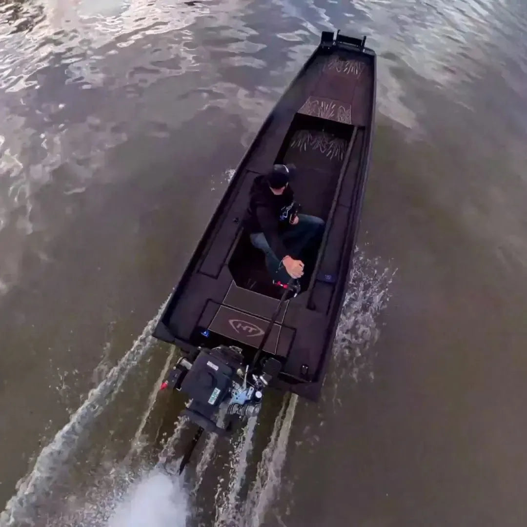 Custom 1436 espresso over black duck boat with mud motor, driven by a person on water.