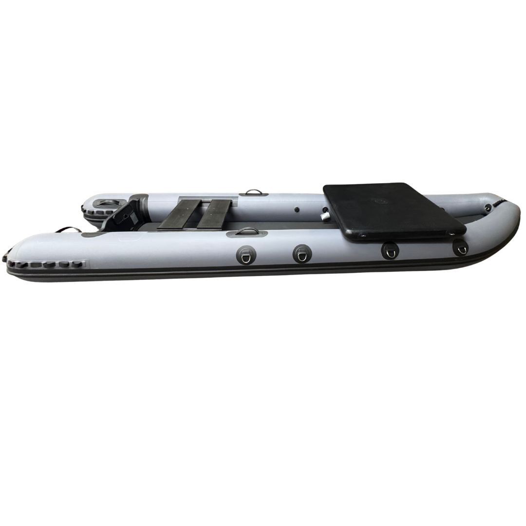 A gray inflatable dinghy boat with black trim, a black seat, and a black storage box, shown from a side profile view against a white background.