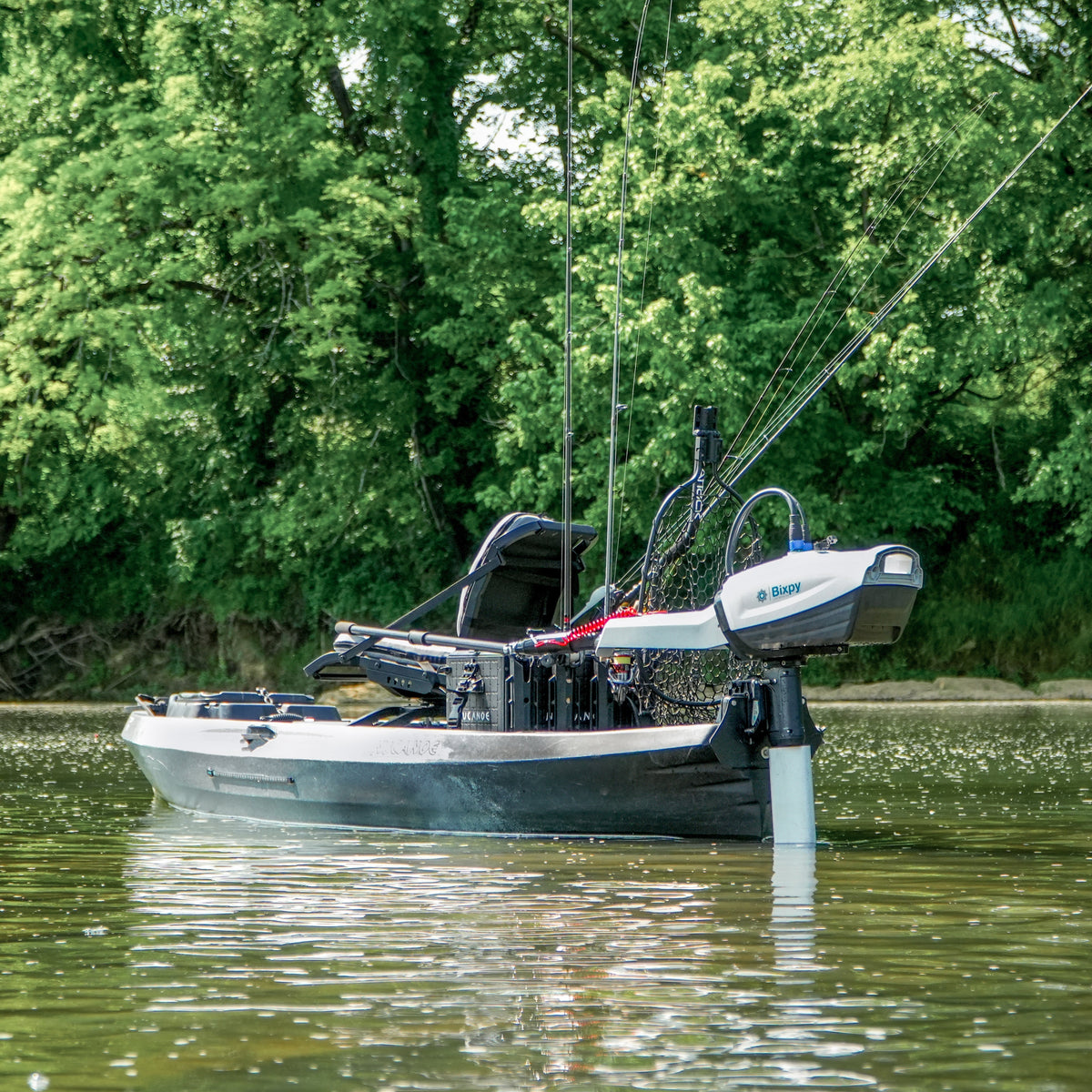 Fishing boat on a calm body of water with trees in the background