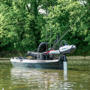 Fishing boat on a calm body of water with trees in the background