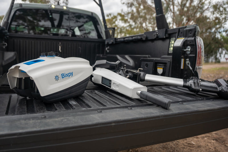 Bixpy device on a truck bed with a blurred background