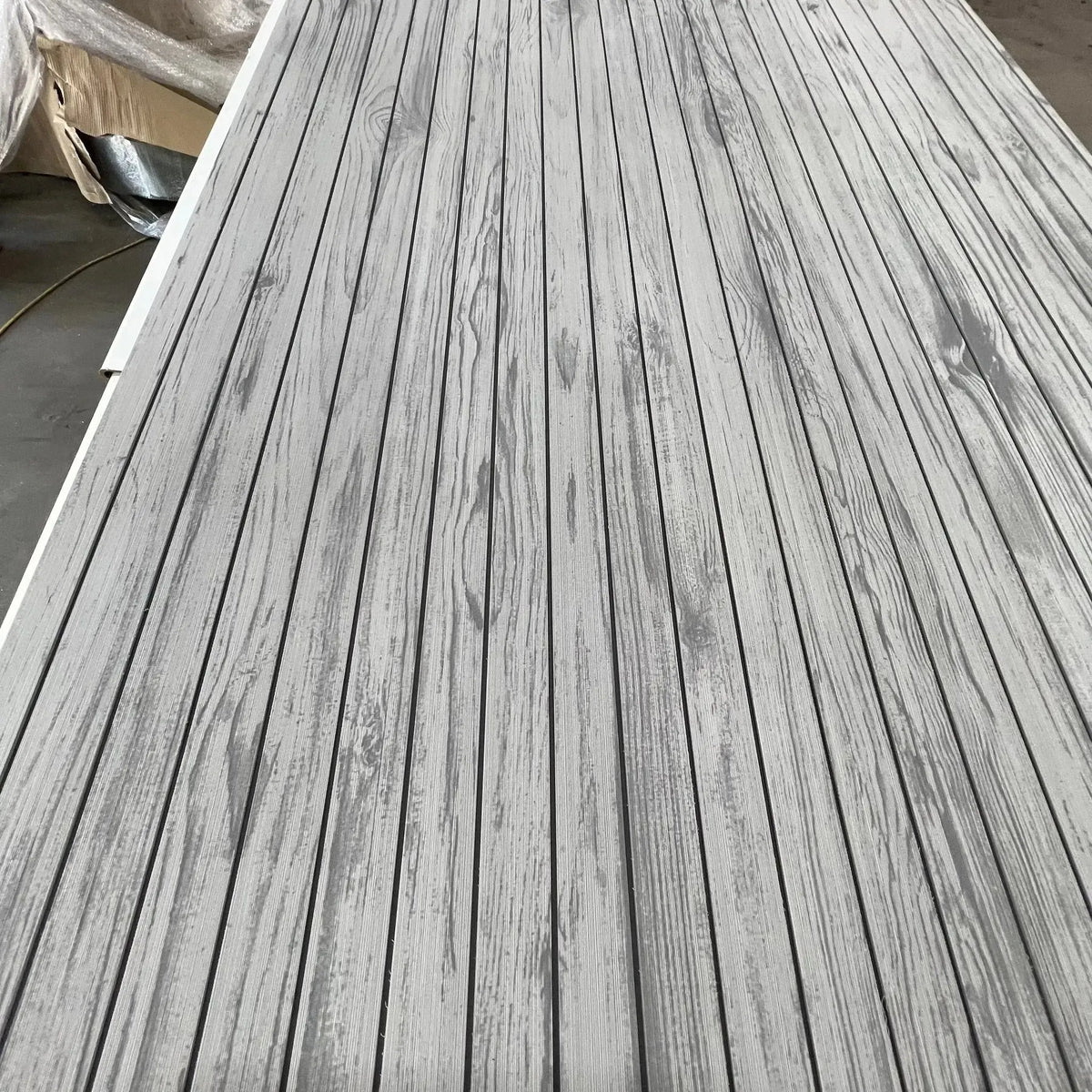 Hydro-Turf Wide Groove Laser Wood Grain EVA foam boat decking sheet in weathered gray.