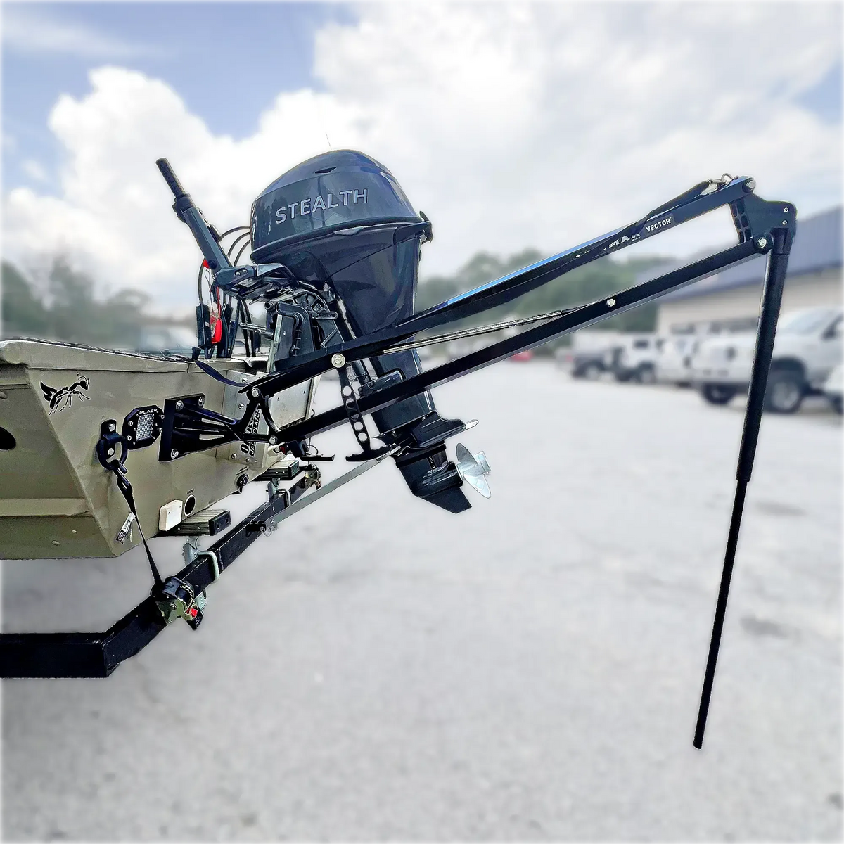 Black Lewmar Vector manual shallow water anchor mounted on a tan jon boat transom with a black outboard.