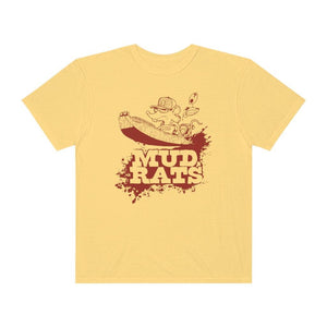 A pale yellow short-sleeve t-shirt with a brown graphic of a cartoon character in a boat above the text 'MUD RATS' on a white background.