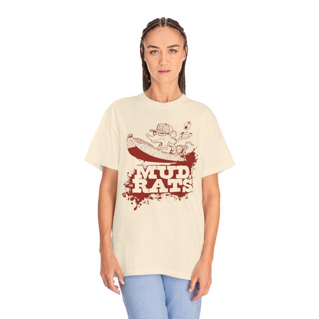 A woman modeling a cream-colored t-shirt with a red graphic print that reads 'MUD RATS' with a cartoon mud rat illustration, set against a plain white background.