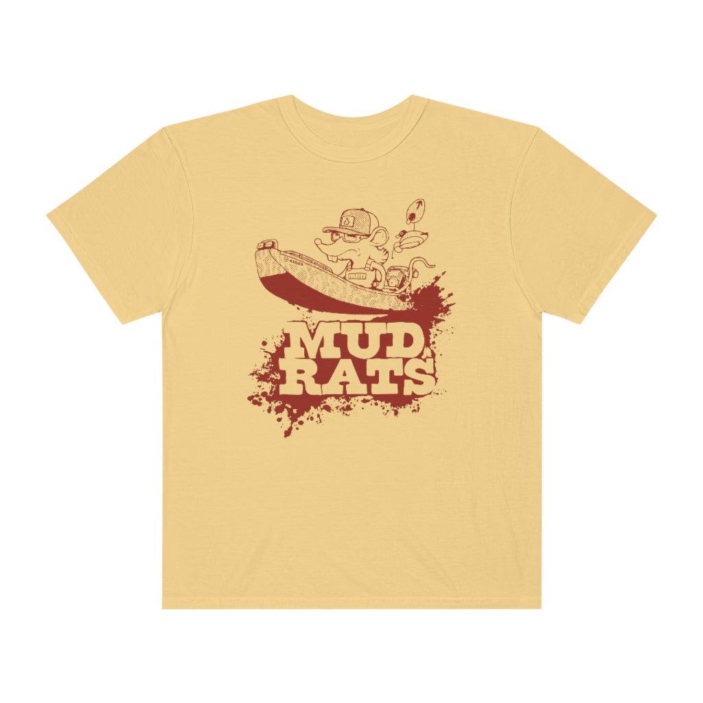 A pale yellow short-sleeve t-shirt with a dark red graphic on the front showing a cartoon character in a boat above the text 'MUD RATS' on a splattered background.