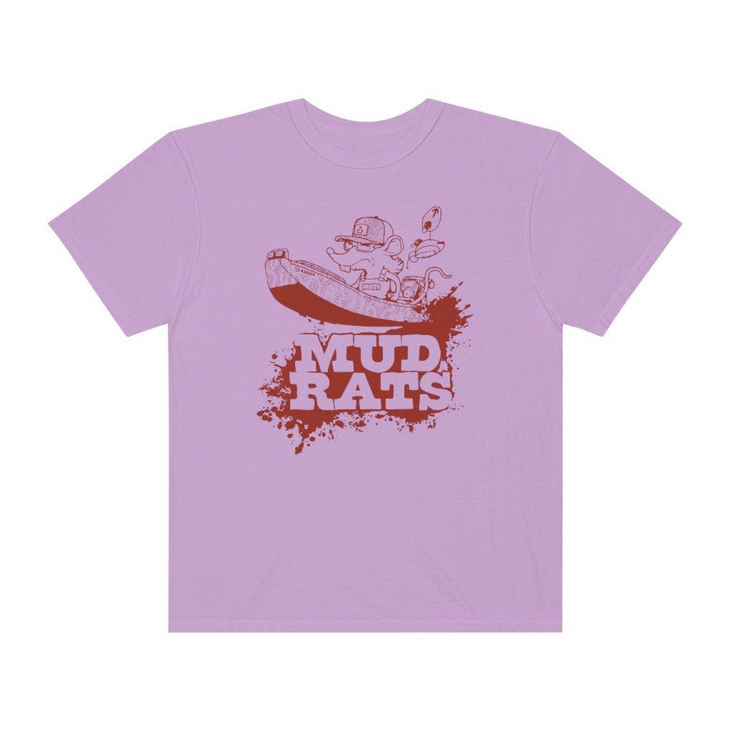 A light purple short-sleeve crewneck t-shirt featuring a red graphic print of a cartoon character in a boat with the text 'MUD RATS' underneath, displayed on a solid white background.