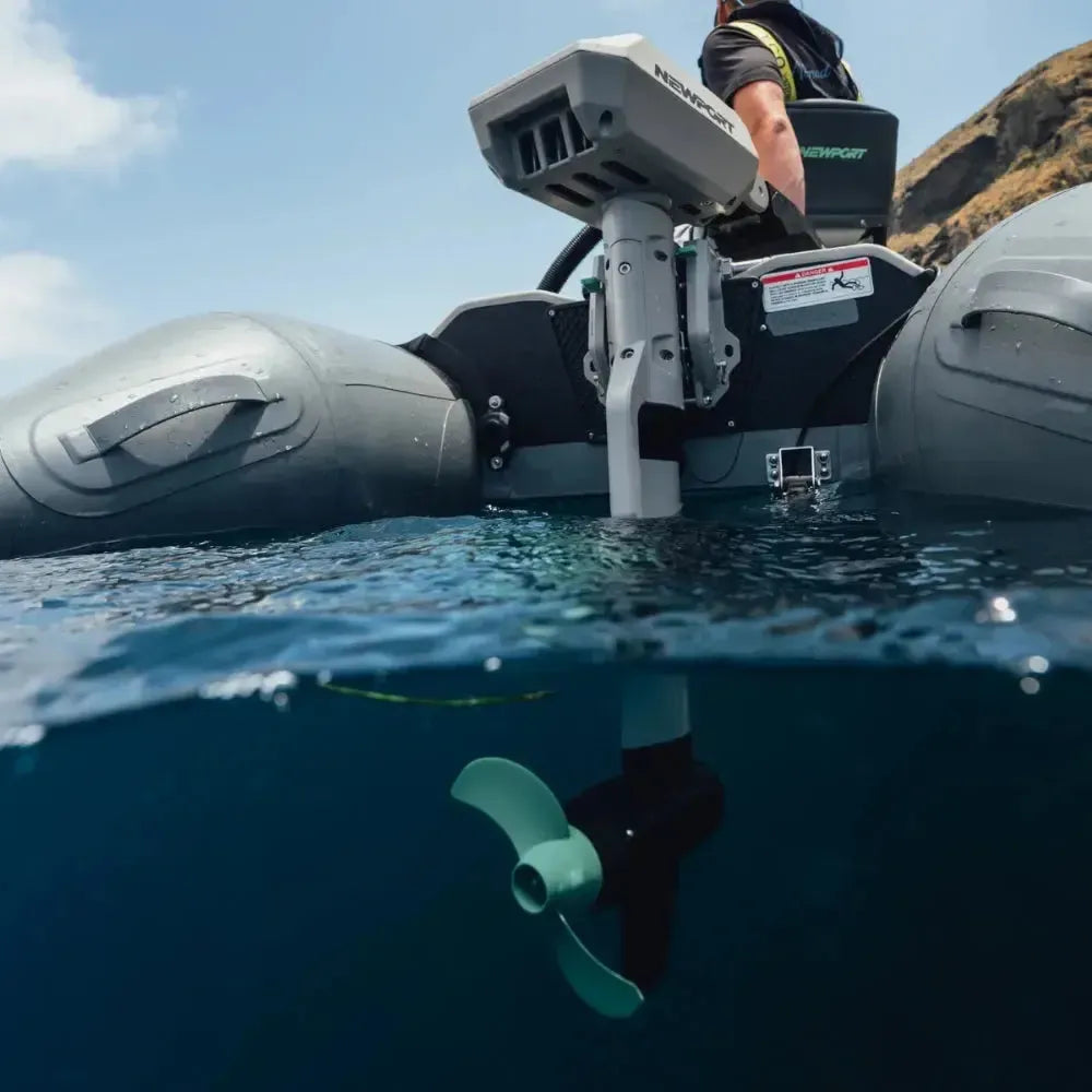 Newport NT600 6hp electric outboard motor with a light green propeller on a gray inflatable boat.