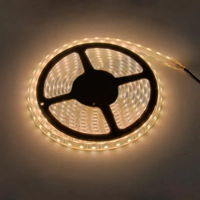 Coiled waterproof LED light strip, glowing amber, for trailer lighting.