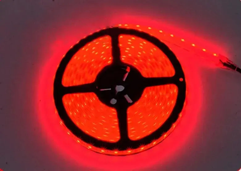 Red LED light strip, coiled on a black spool, glowing brightly.