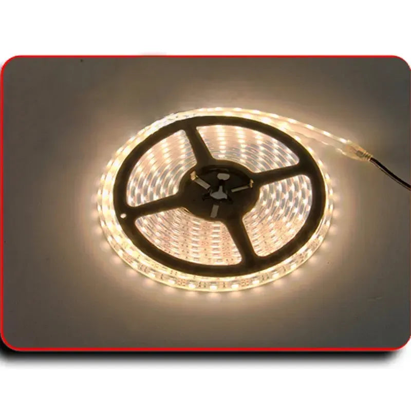 Coiled PlashLights IP68 waterproof flexible LED light strip, emitting warm white illumination.