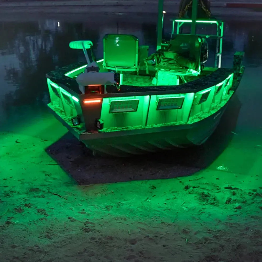 Green RGBW Plashlight flexible LED strip illuminating a boat on water at night.