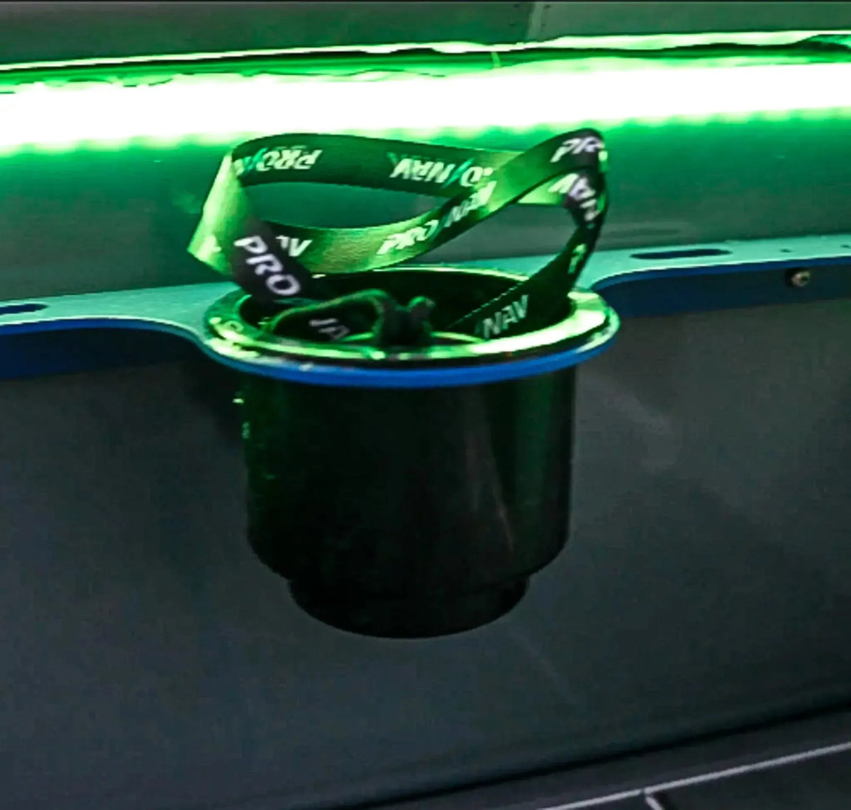 Green Plashlight 12V RGBW flexible light strip illuminating a black cup holder with a blue rim.