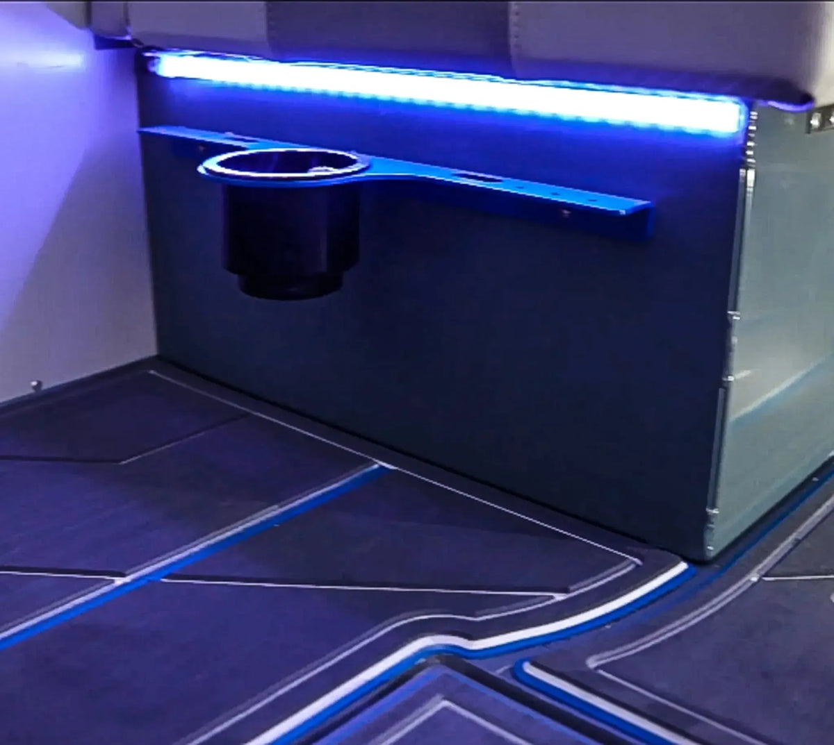 Blue Plashlight 12V RGBW flexible light strip illuminating a boat interior with a cup holder.