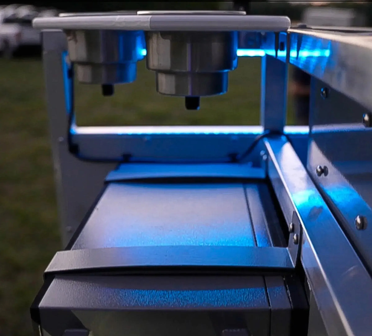 Plashlight 12V RGBW flexible light strip illuminating a metal outdoor bar with blue light.
