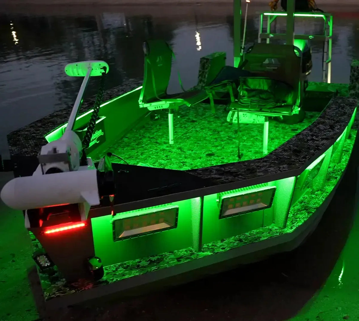 Green RGBW Plashlight flexible LED strip illuminating a boat interior and exterior at night.