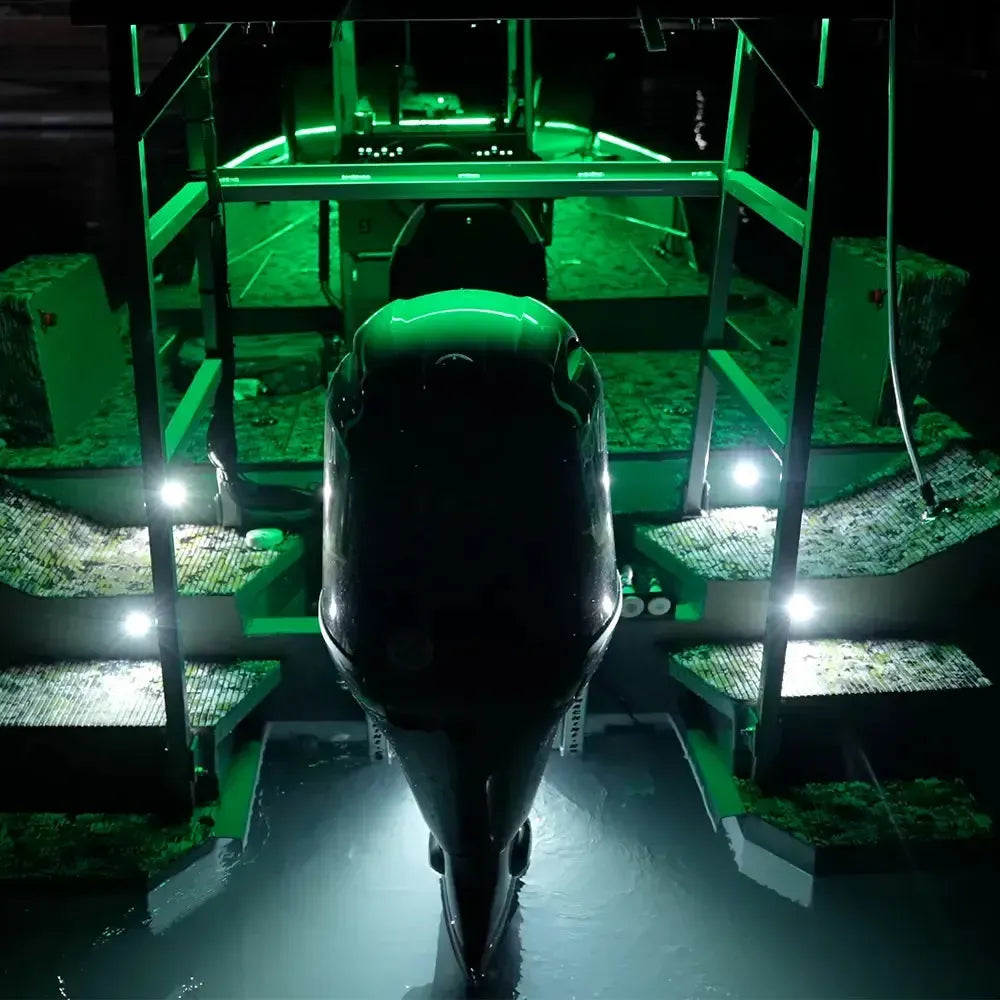 Green Plashlight RGBW flexible light strips illuminating a boat's deck, gunnels, and surrounding water.