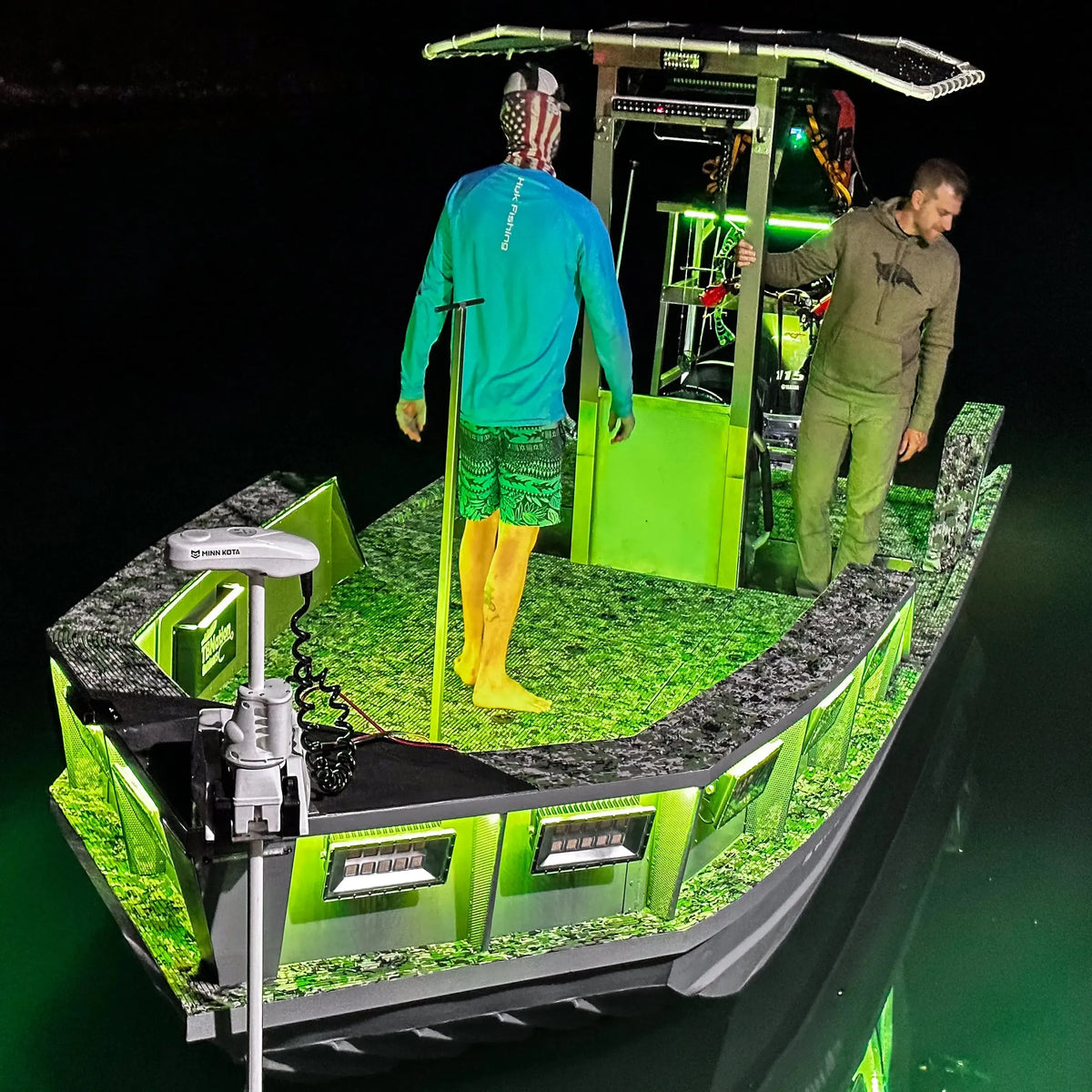 Green RGBW Plashlight strip illuminating a boat interior and surrounding water at night.
