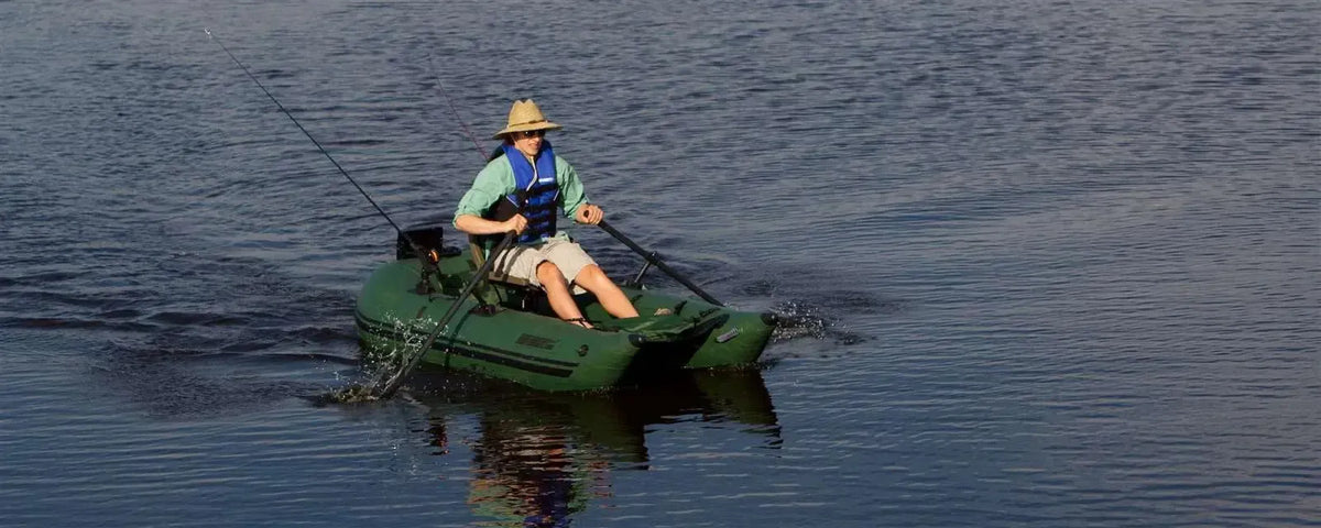 Hunter Green Sea Eagle 285 Frameless Pontoon Boat with a person rowing, fishing on calm water.