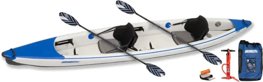 White and blue Sea Eagle 473rl inflatable tandem kayak with two paddles, pump, and storage bag.