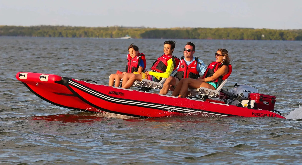 Red Sea Eagle FastCat14 inflatable catamaran with four people in life vests on open water.