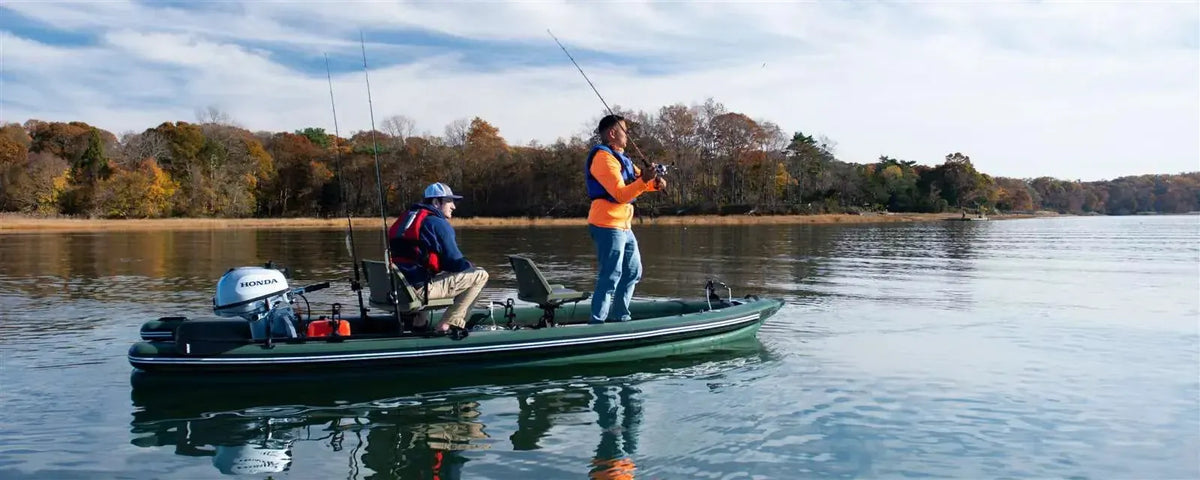 Two men fishing from a green Sea Eagle FishSkiff 16 inflatable boat with a Honda outboard motor.