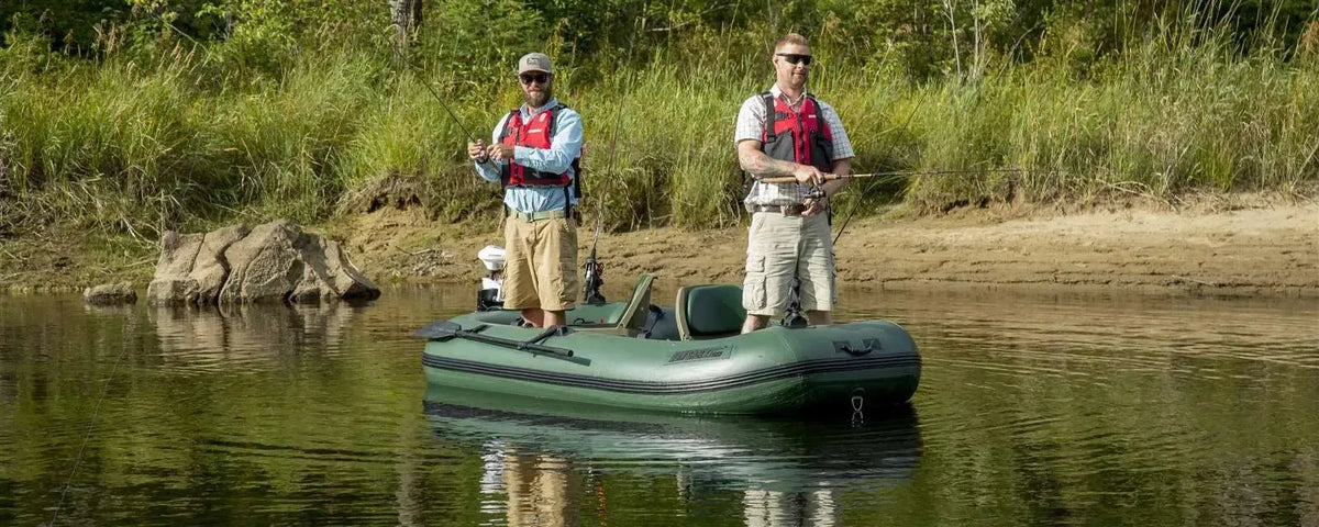 Two men fishing from a Hunter Green Sea Eagle Stealth Stalker 10 inflatable boat on a calm river.