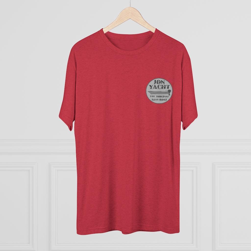 A red short-sleeve crewneck t-shirt hanging on a light wood hanger against a white paneled wall. The shirt features a circular gray graphic on the left chest with the text 'JON YACHT' and 'THE ORIGINAL JON YACHT BRAND'.