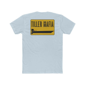 A light blue heather crewneck t-shirt shown from the back, featuring a yellow rectangular graphic with the text 'TILLER MAFIA' in black and a black tractor graphic.