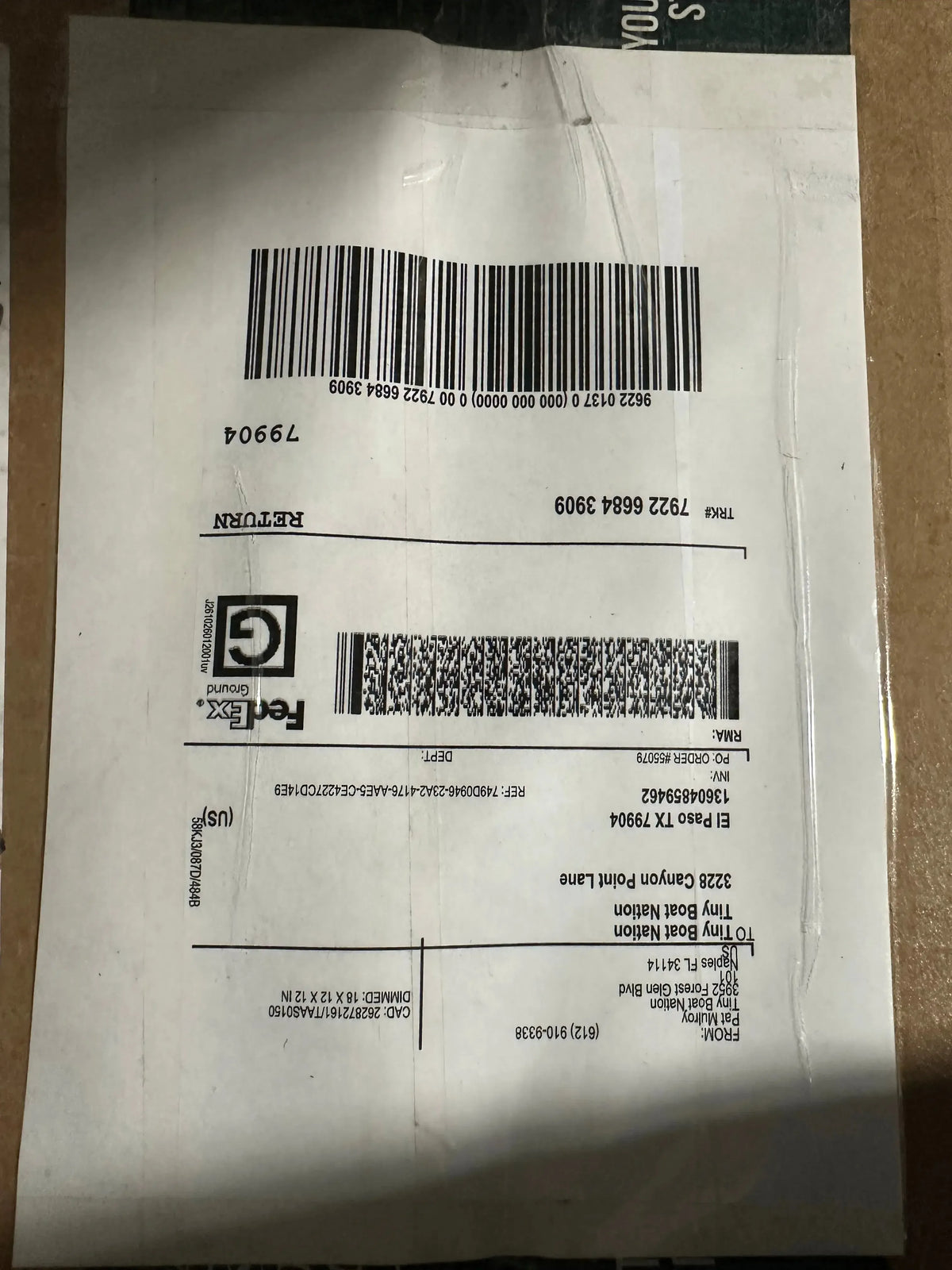 Barcode label on a white sheet with text and symbols.