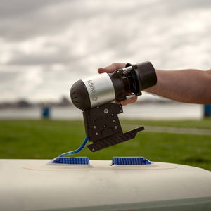 Person using a Flexrotor device on a boat with a cloudy sky background