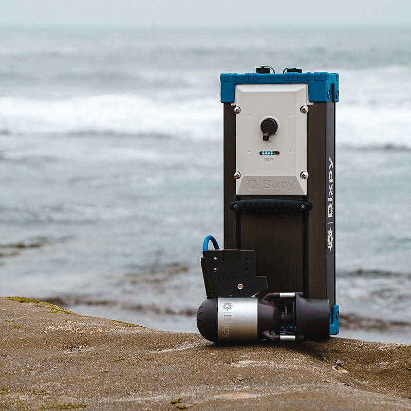 Portable water filtration system on a concrete surface with a water body in the background