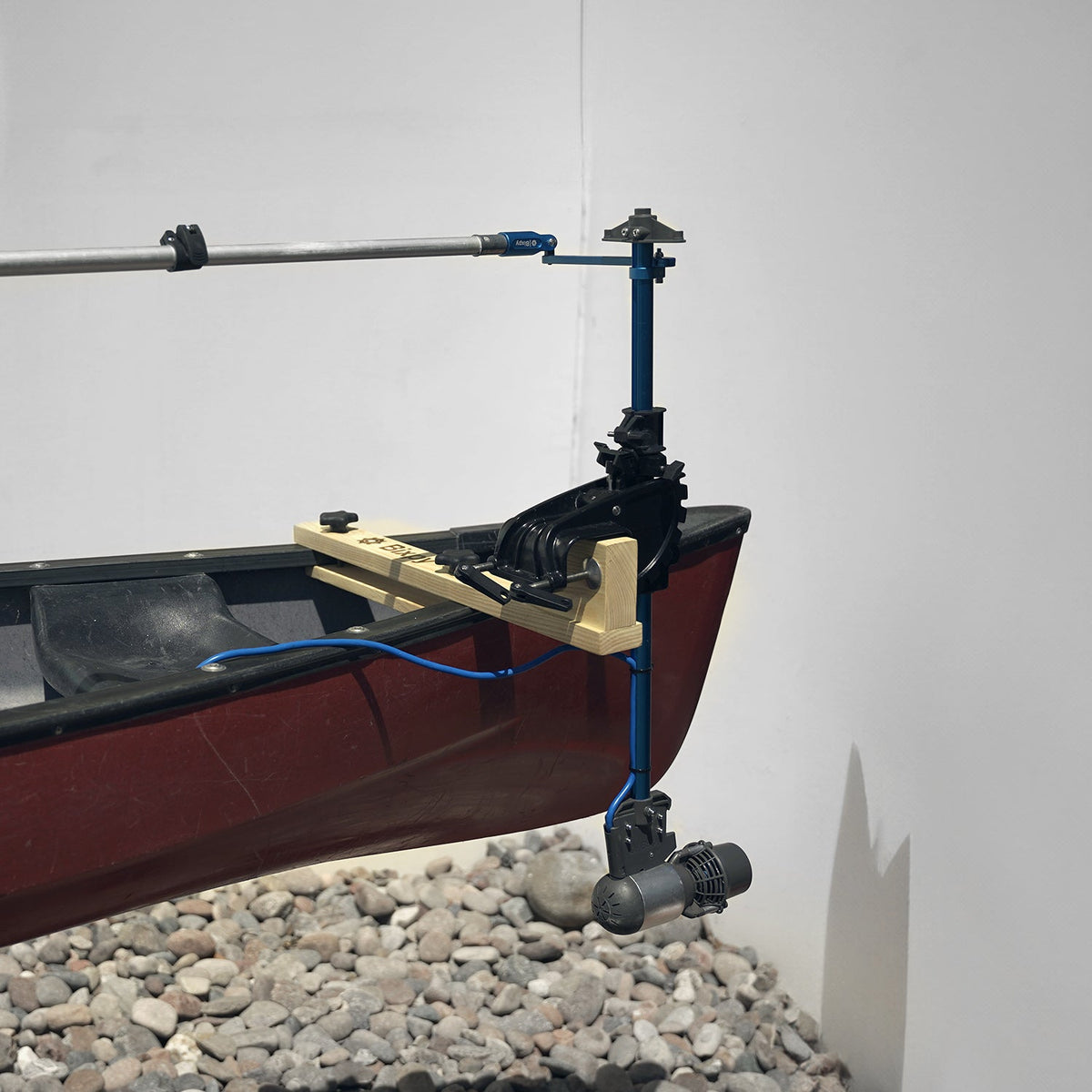 Model of a boat with a motor and cable system on a white background