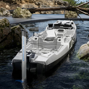 A white and black hydrofoil boat with an attached ePropulsion kLite 7500 outboard motor floating on dark water beside rocky banks.