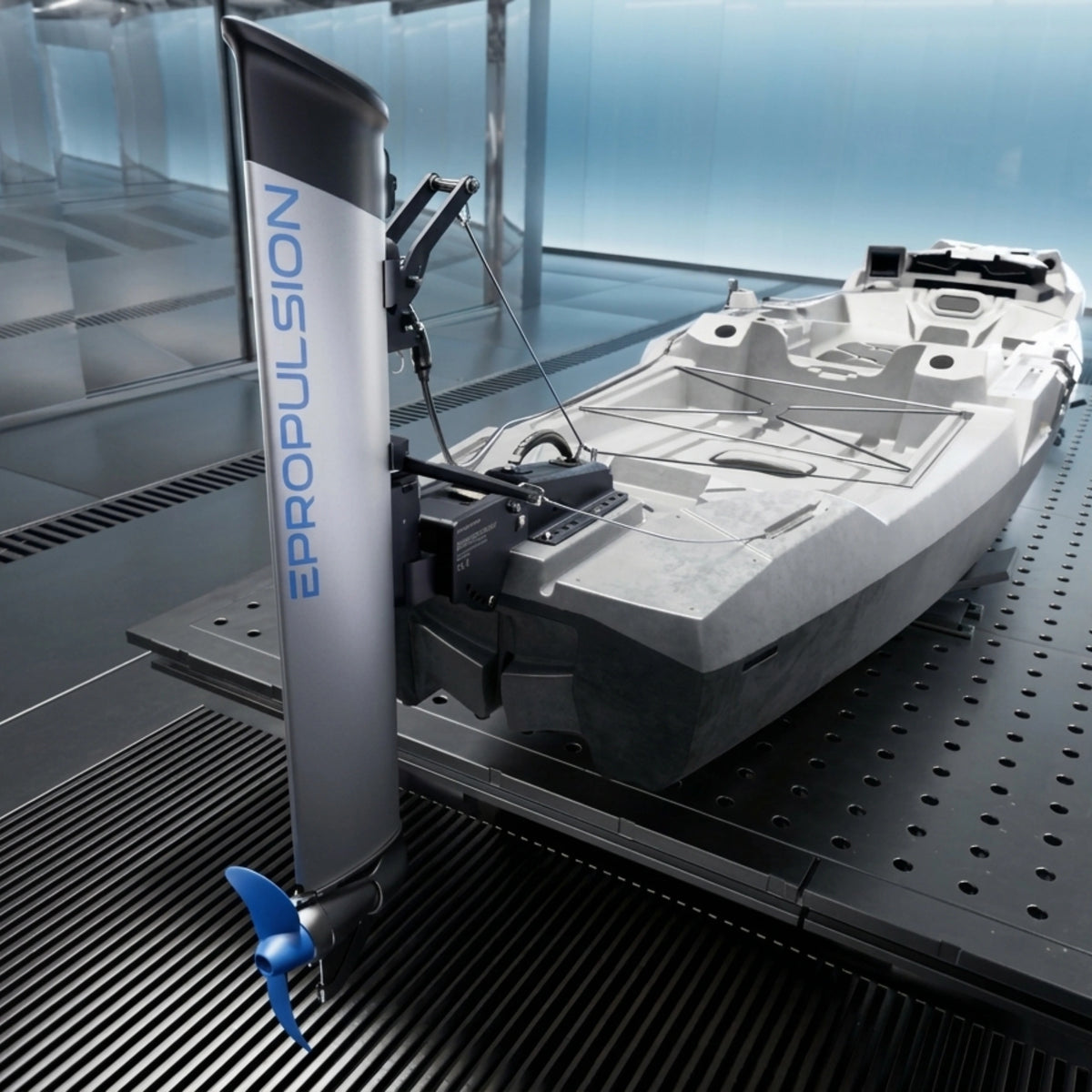 A ePropulsion kLite 7500 outboard motor attached to a small white boat, displayed on a black perforated metal test stand inside a modern blue-toned studio.
