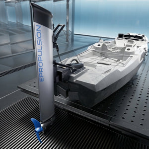 A ePropulsion kLite 7500 outboard motor attached to a small white boat, displayed on a black perforated metal test stand inside a modern blue-toned studio.