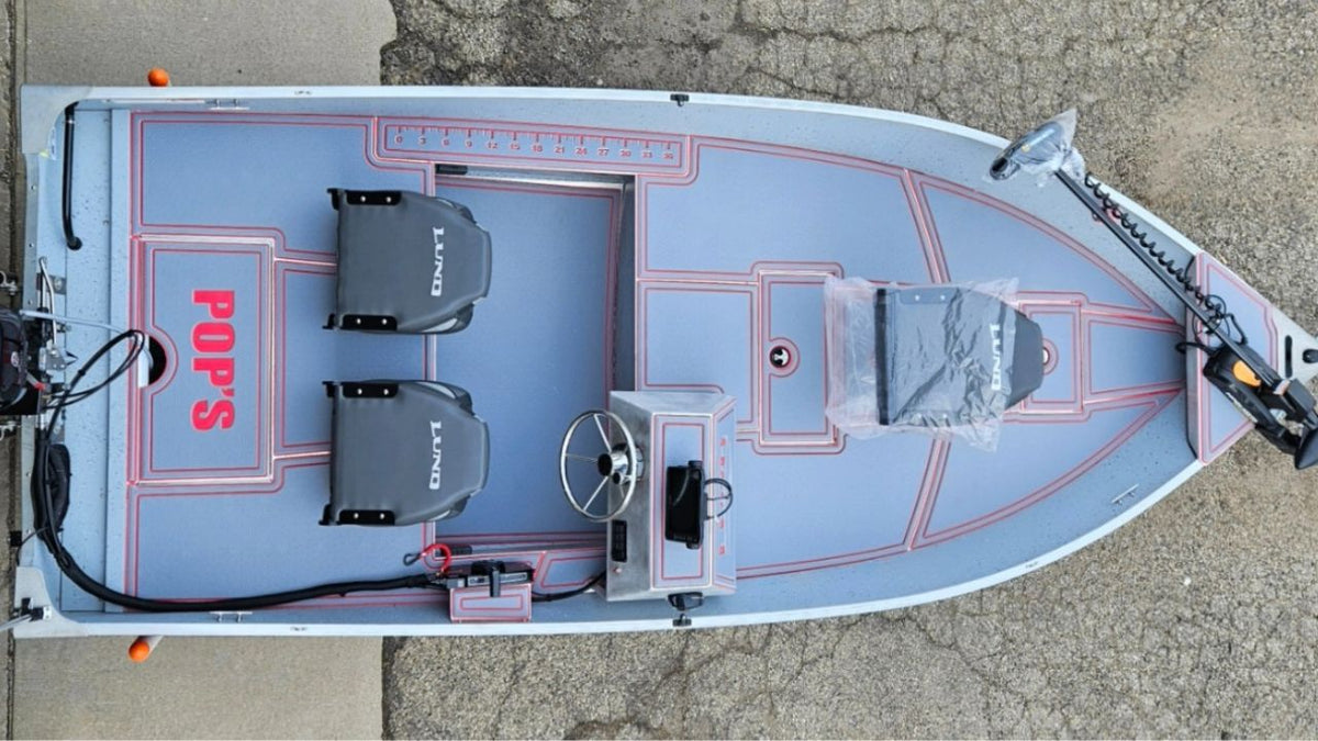 Top-down view of a boat with 'Pops' branding on a concrete surface