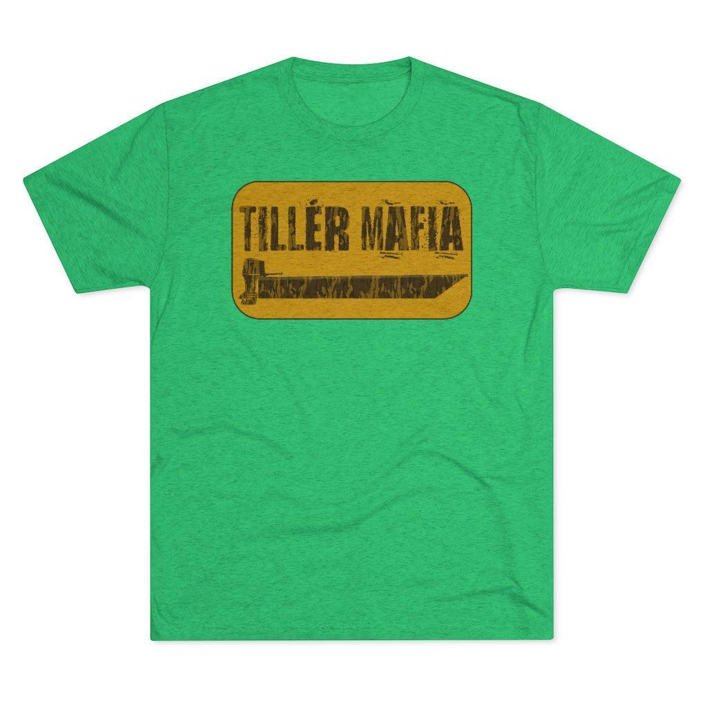 A green heather crewneck t-shirt featuring a distressed yellow rectangular graphic on the chest with the text 'TILLER MAFIA' and a small illustration.