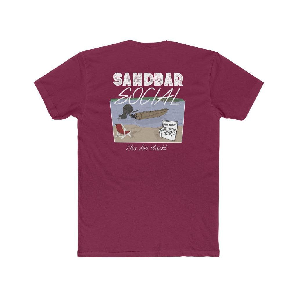 A maroon short-sleeve t-shirt shown from the back, featuring a graphic print with the text 'SANDBAR SOCIAL' and 'The Jon Yacht' above and below an illustration of a surfer on a beach.