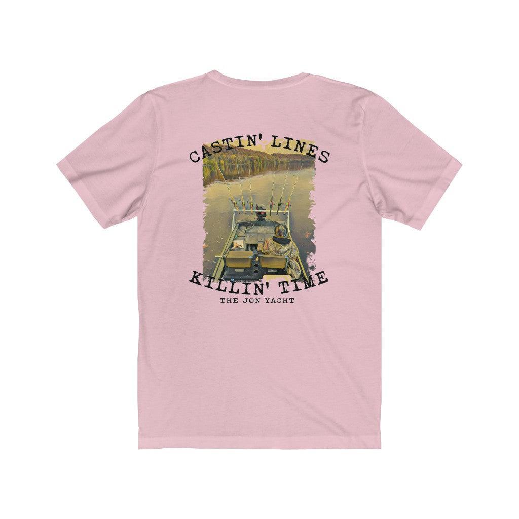 A light pink short-sleeve t-shirt shown from the back, featuring a large graphic print of a fishing boat on a river with the text 'CASTIN' LINES' and 'KILLIN' TIME'.