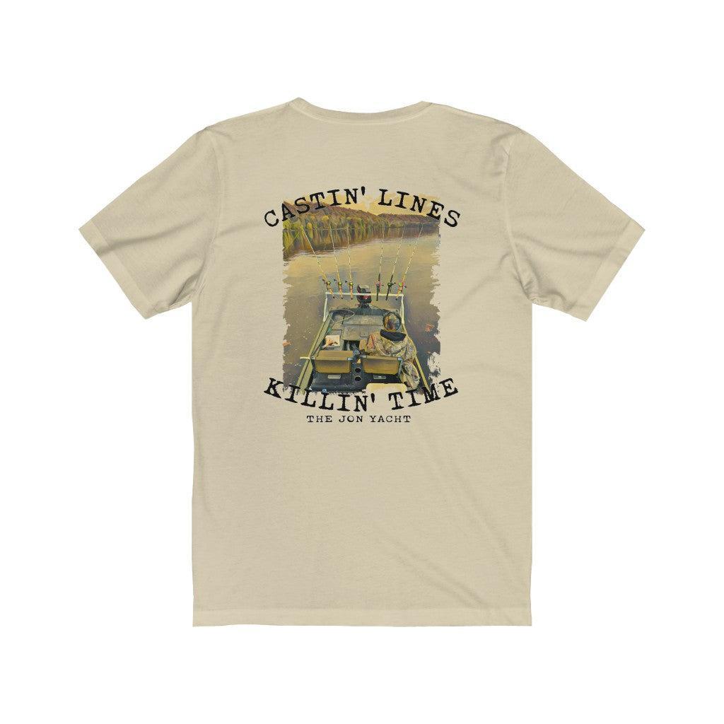 A beige crewneck t-shirt shown from the back, featuring a large graphic print of a fly-fishing scene with a boat and the text 'CASTIN' LINES' and 'KILLIN' TIME' with 'THE JON YACHT underneath.
