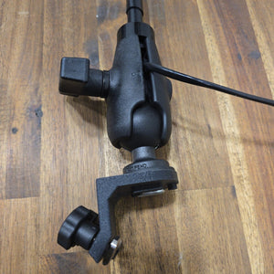 Assembled 45° T-Bolt Mount Package on a wooden surface, showing the angled track bracket with tightening knob, ball-and-socket clamp arm, and attached LED light pole with wiring.