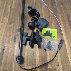 Disassembled 45° T-Bolt Mount Package components laid out on a wooden surface, featuring the LED navigation light pole, wiring harness, ball mount, double-socket clamp arm, angled track brackets, and packaged Max Storage Hook kit.
