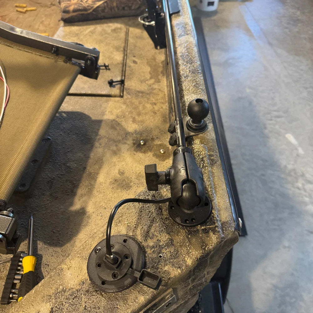 Max It Out LEDs Premier Universal LED Stern Light installed on a boat gunwale and folded down flat for storage, showing the adjustable ball mount and power cable plugged into the flush socket.