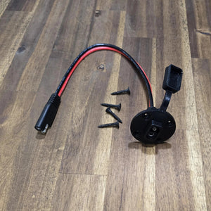 Max Power Socket and wiring harness included with the Max It Out LEDs Premier Universal LED Stern Light Kit, shown with an attached rubber protective cap and four black mounting screws on a wooden surface.